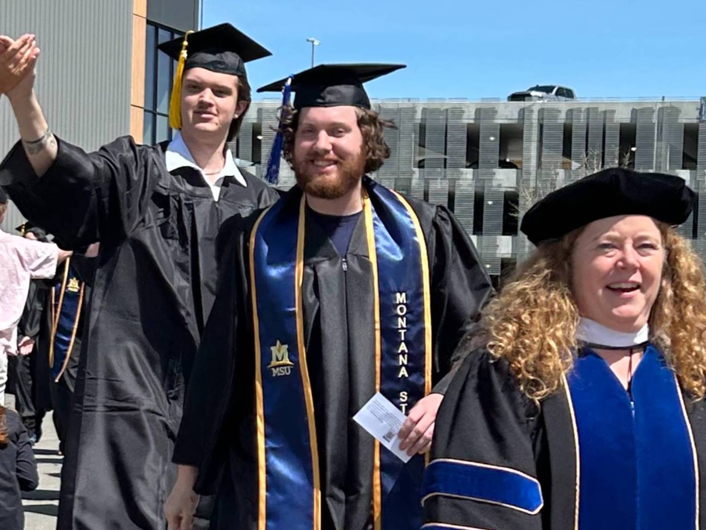 two grads with assistant dean for student success and retention, Jen Dunn