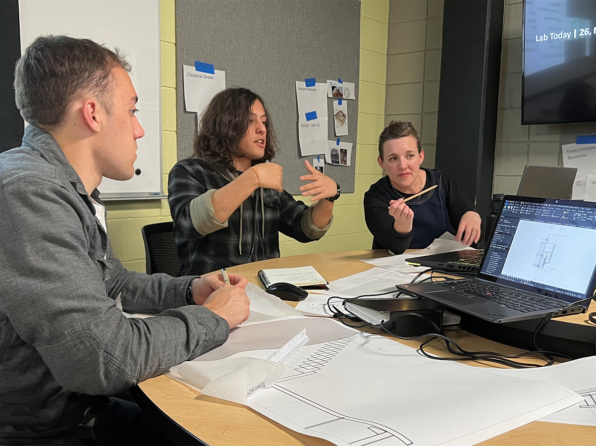 Advisory Council member meets with students to discuss project work.