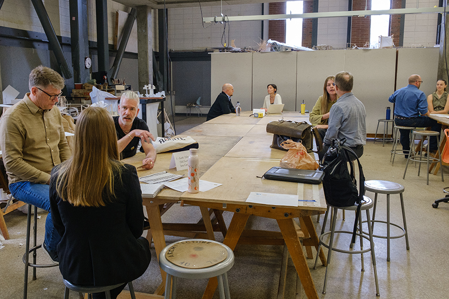 Alumni conducting practice interviews with students in a design studio space
